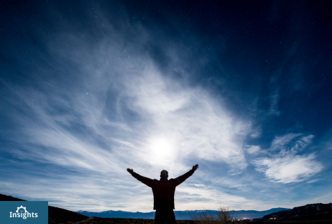 Man Raises Arms Towards Sky
